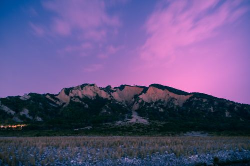 Free Stunning twilight view of rocky mountains under a vibrant purple sky. Stock Photo