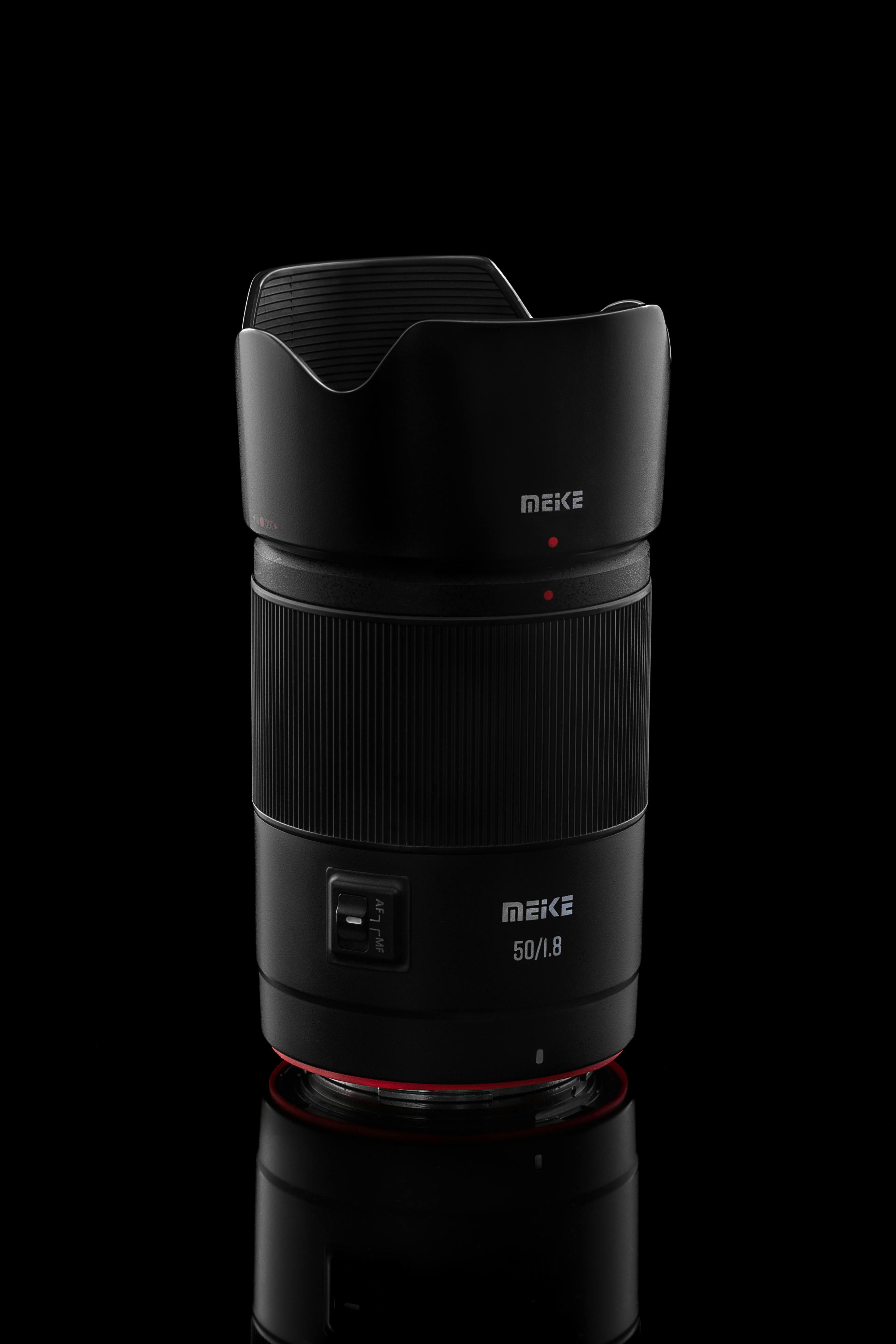 Professional photo of a Meike 50mm f/1.8 lens isolated on a black background. Perfect for photography enthusiasts.
