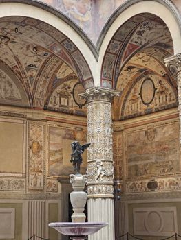 Explore the rich architectural details of a Renaissance courtyard in Florence, Italy.