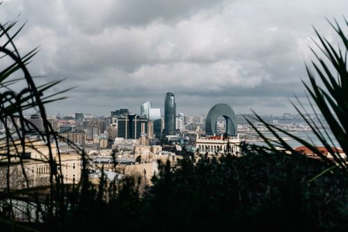 Free Scenic view of Baku's skyline with modern architecture under cloudy sky. Stock Photo