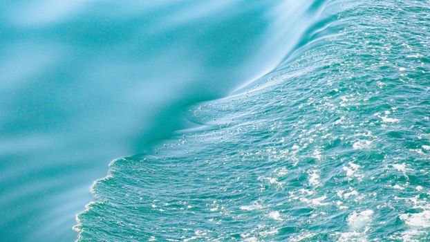Captured in Dali, China, this image reveals the dynamic texture of ocean waves in brilliant turquoise.
