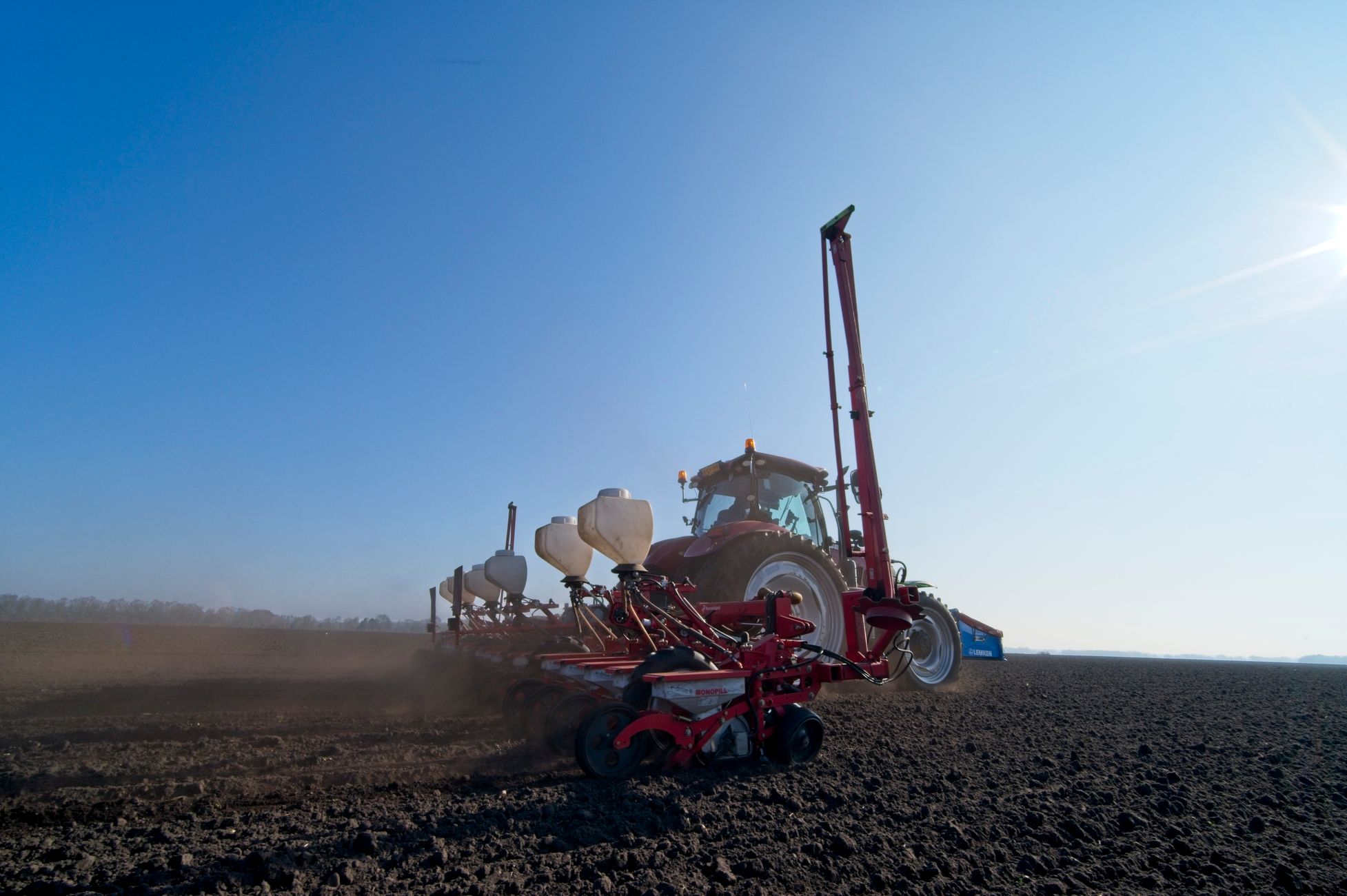 Tractor met veldspuit kantelt en belandt in de berm