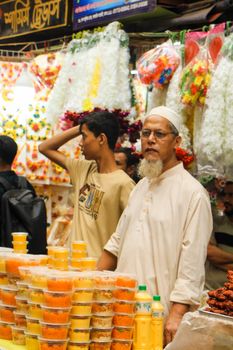 Vibrant market scene with shoppers and colorful goods in Dhaka, Bangladesh.