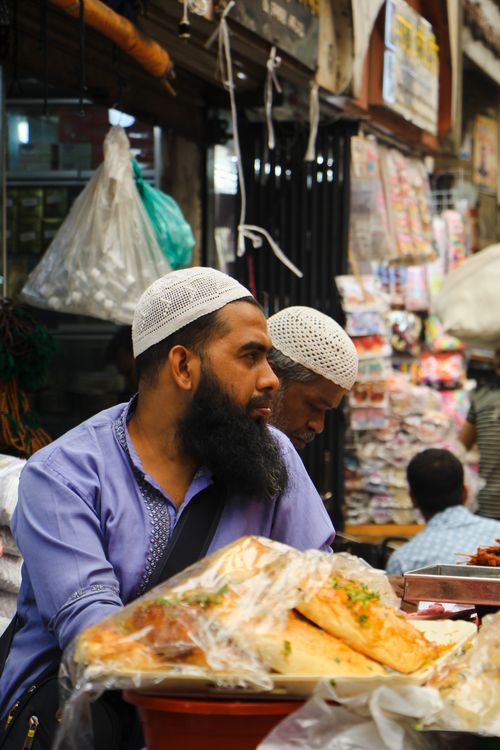 Free A street vendor selling food in a vibrant market in Old Dhaka, Bangladesh. Stock Photo