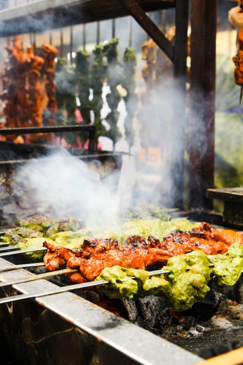 Free A vibrant display of colorful, juicy kebabs being grilled in a Dhaka street market. Stock Photo