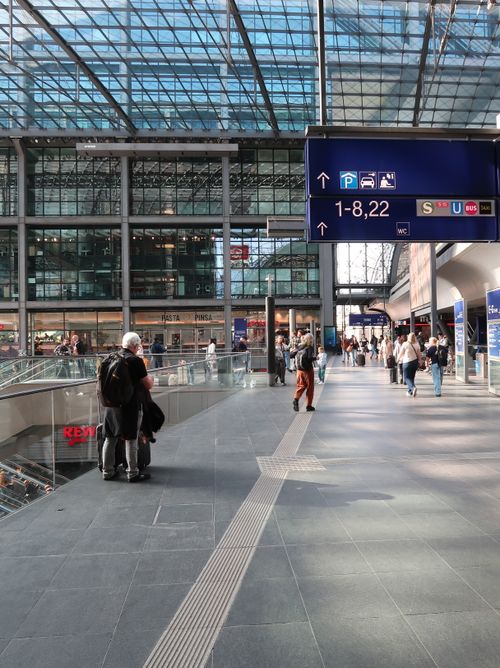 Free A bustling modern train station with people and signage, showcasing urban travel life. Stock Photo