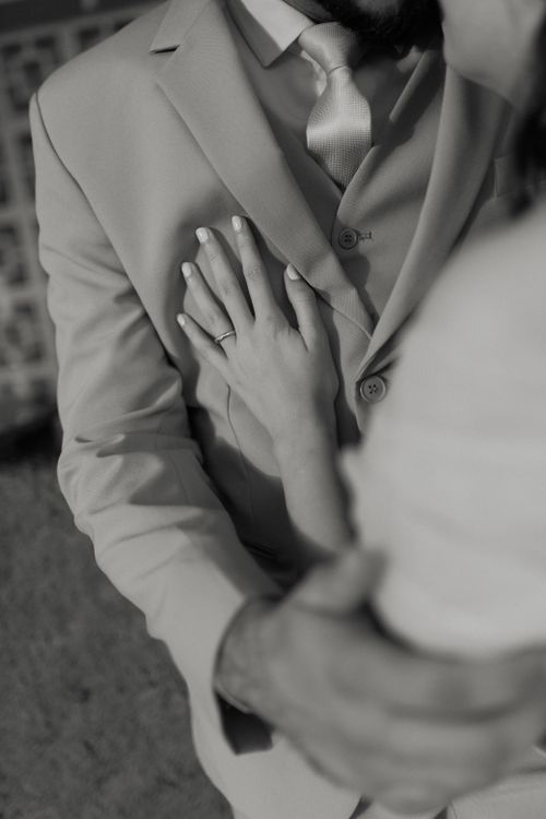 Free A monochrome close-up image showcasing a newly engaged couple in an intimate and affectionate embrace. Stock Photo