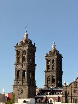 Captivating view of Puebla Cathedral bell towers in Mexico under a clear blue sky.