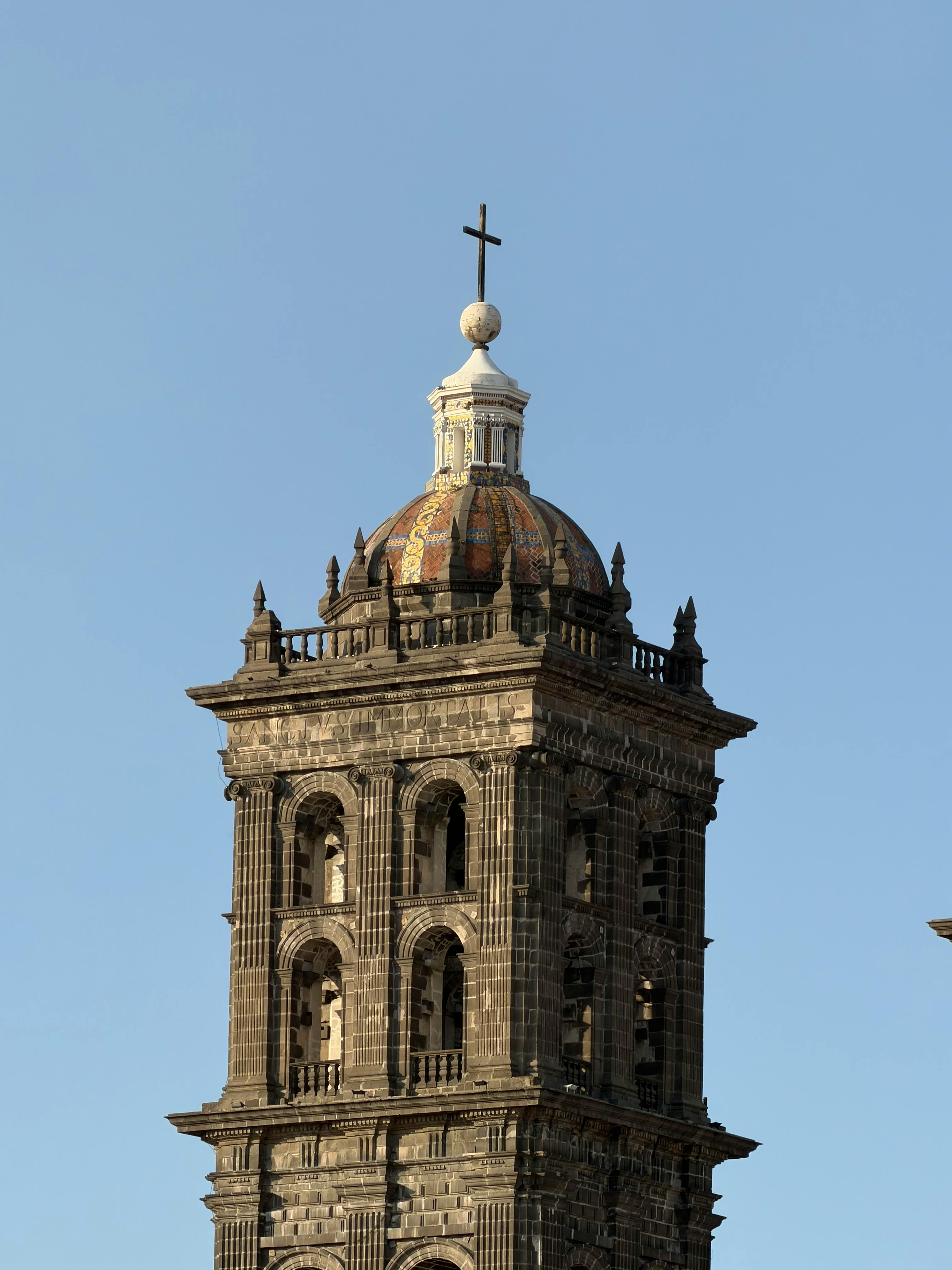 Ücretsiz Puebla Katedrali'nin göz alıcı çan kulesinin, berrak mavi gökyüzü önünde çekilmiş yakın plan fotoğrafı. Stok Fotoğraflar