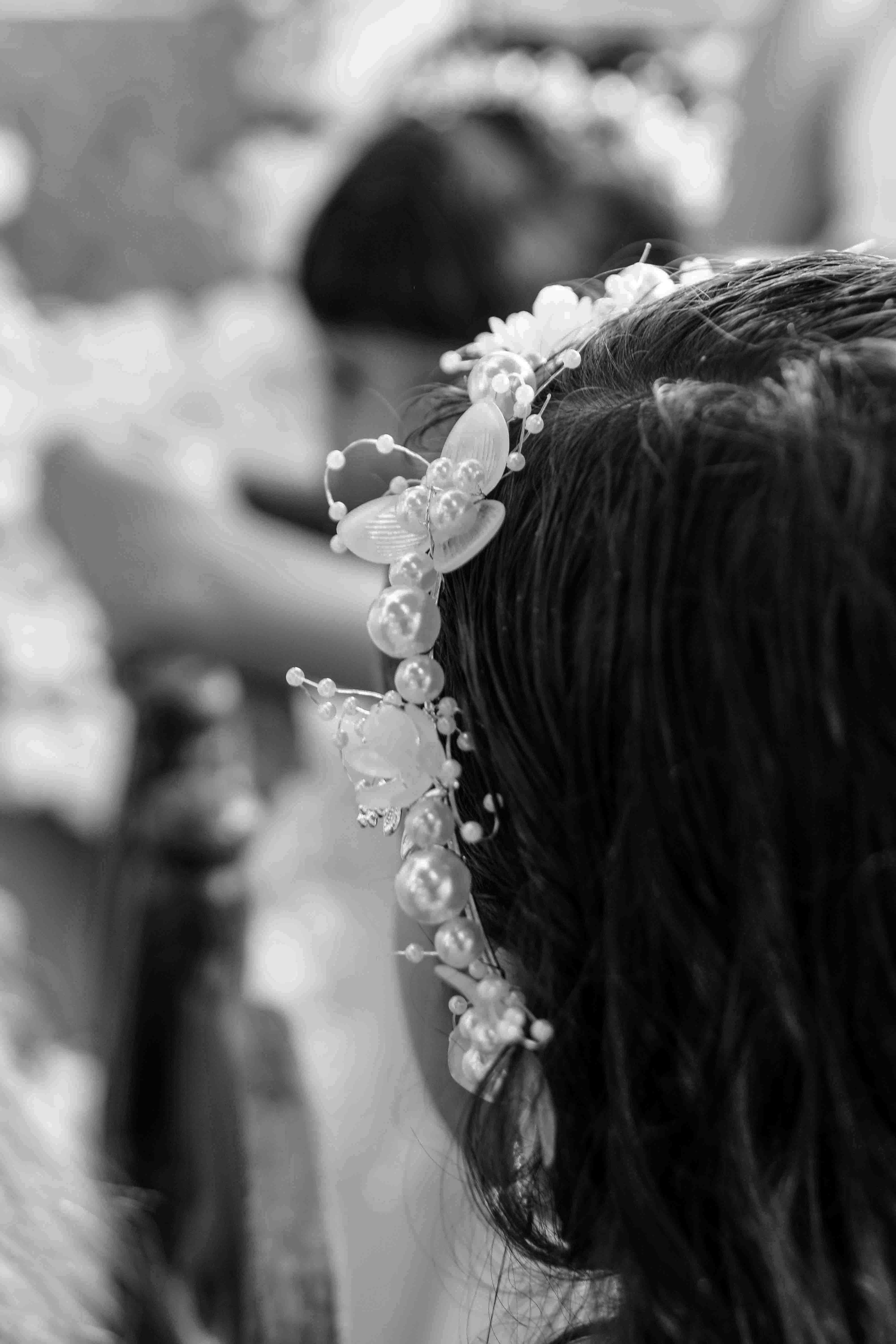 Free A delicate floral headpiece adorns a child's hair in a beautifully captured black and white setting. Stock Photo