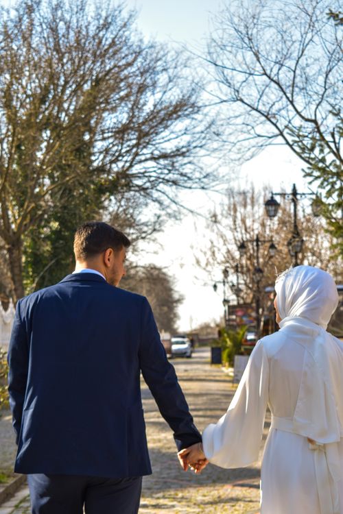 Free A couple walking hand-in-hand on a sunny day in Edirne, Türkiye, showcasing love and companionship. Stock Photo