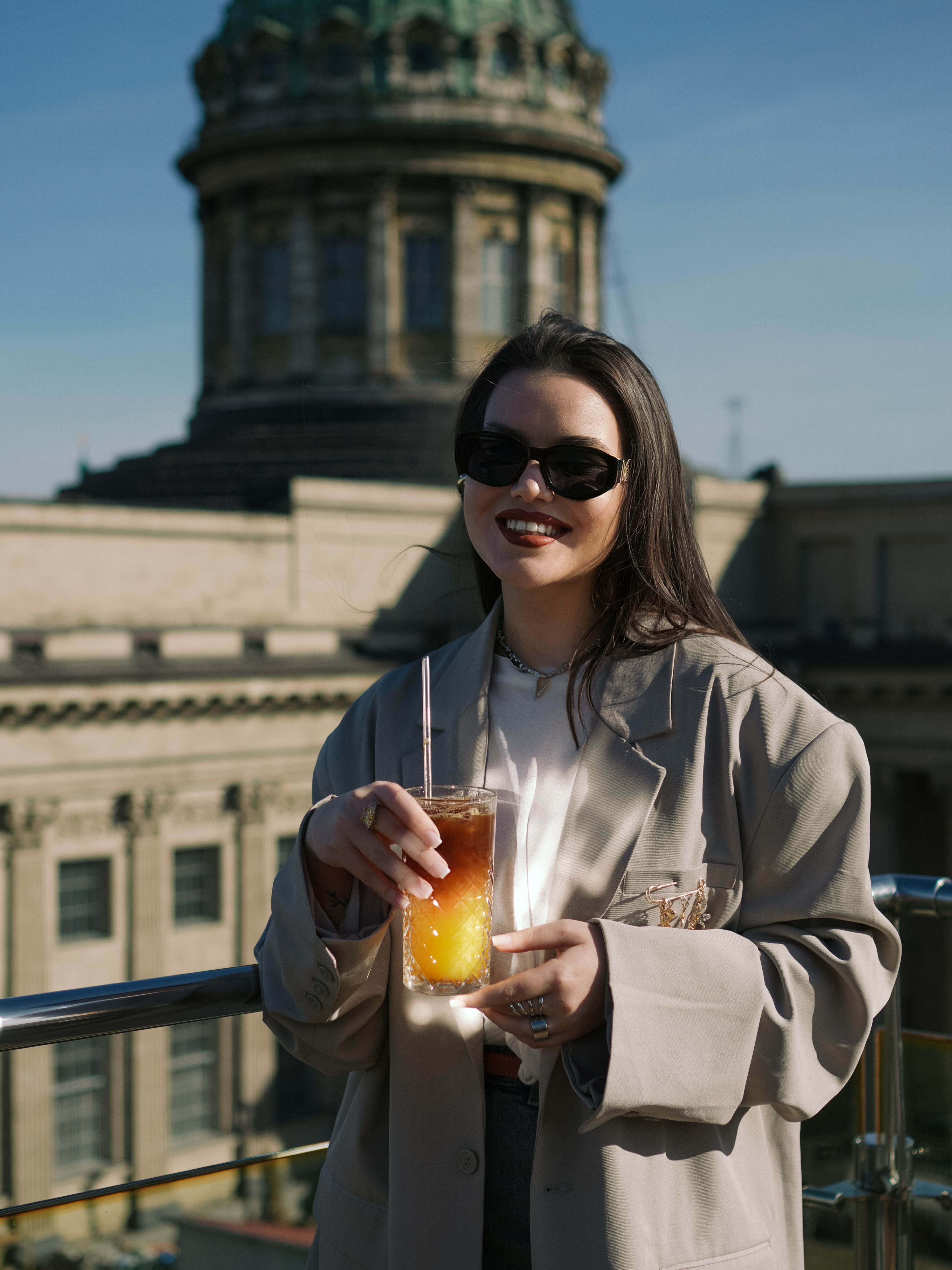 Woman Enjoying Iced Tea on Urban Rooftop · Free Stock Photo