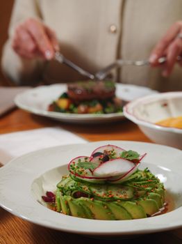 Gourmet avocado and radish salad elegantly plated, perfect for fine dining presentation.