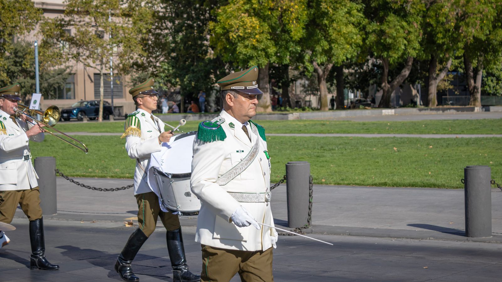 Chilean national police band performing in public parade in Santiago, Chile. Formal uniforms and instruments displayed.