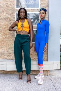 Two friends in colour-blocked outfits on a stoop — photo by Elkies Lens on Pexels
