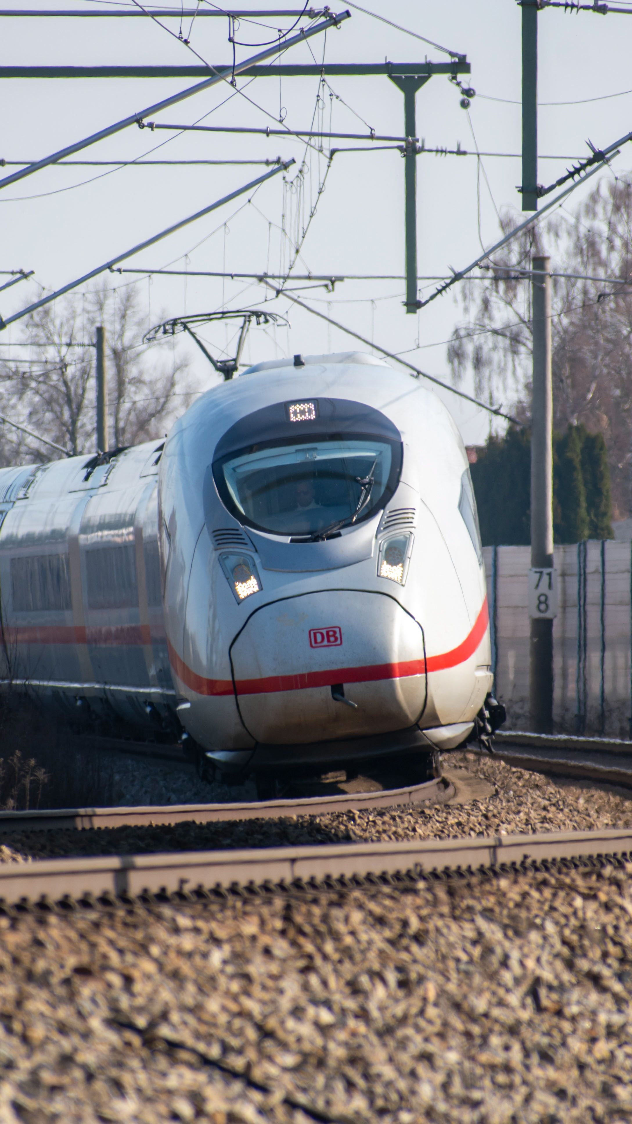 A sleek high-speed train on track in bright daylight in Bavaria, Germany.