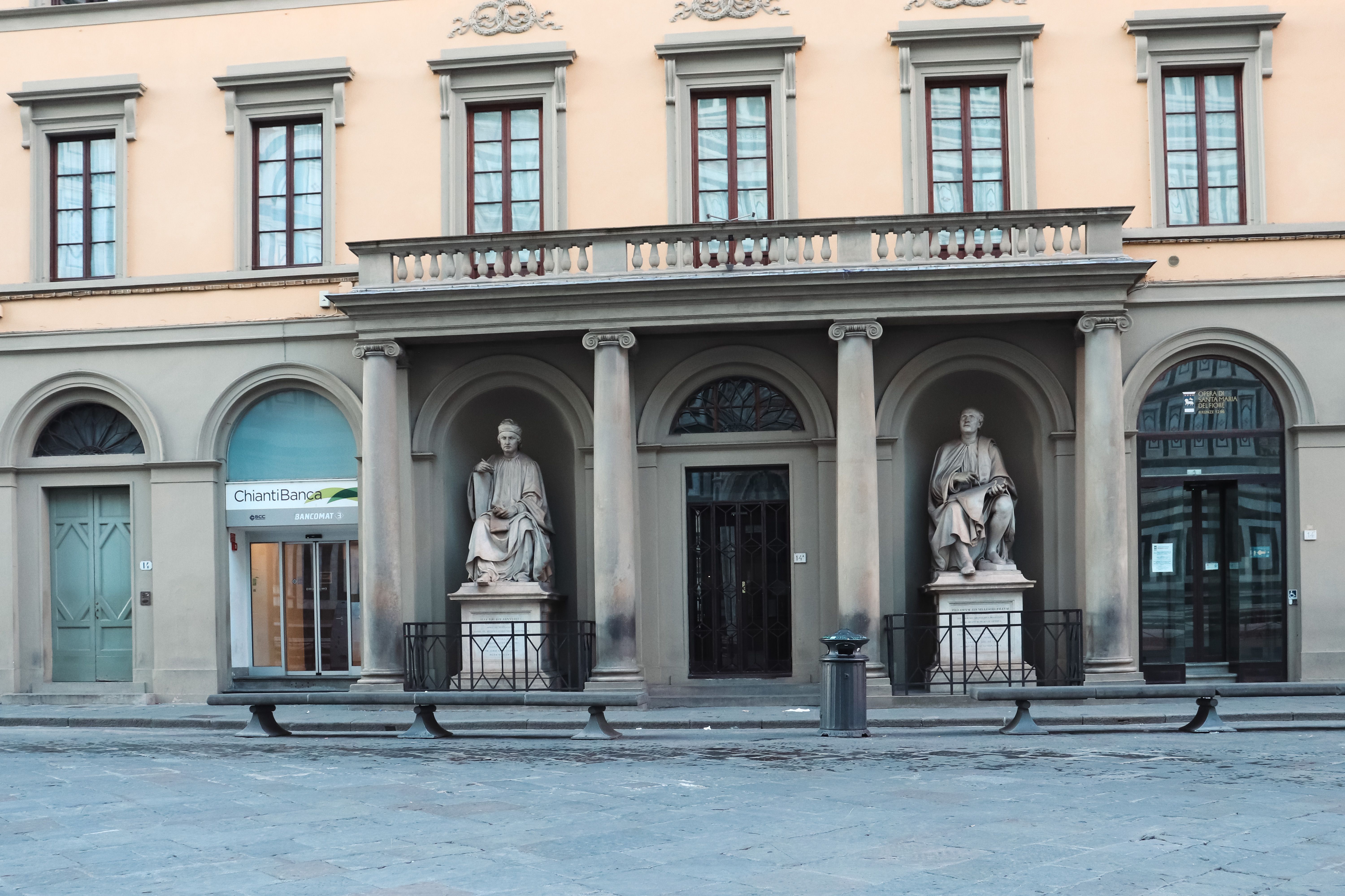Facade with classic statues in Florence, Tuscany; showcasing Italian architectural elegance.