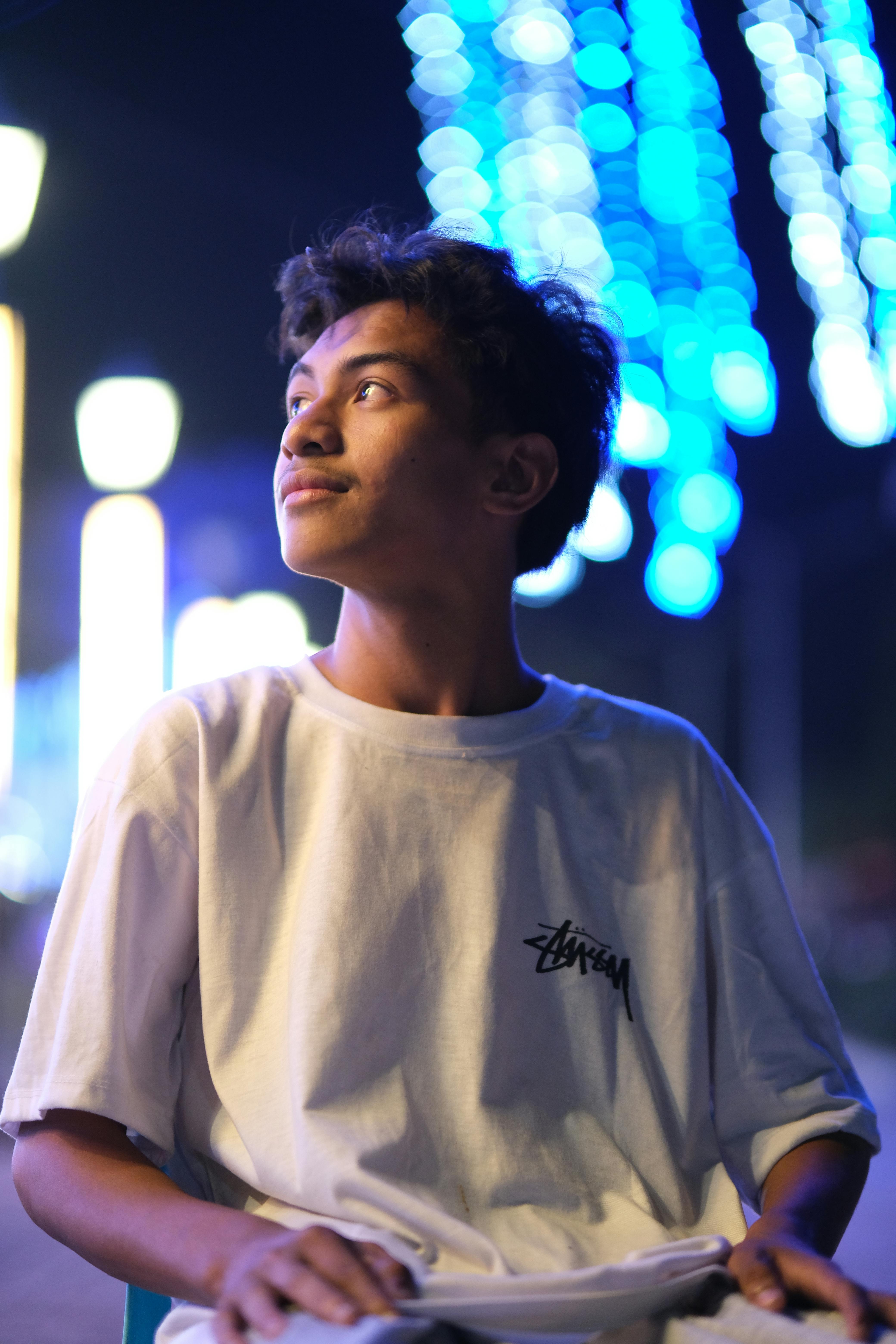 Gratis Una adolescente contempla las brillantes luces de la ciudad, capturando una vibrante escena nocturna. Foto de stock