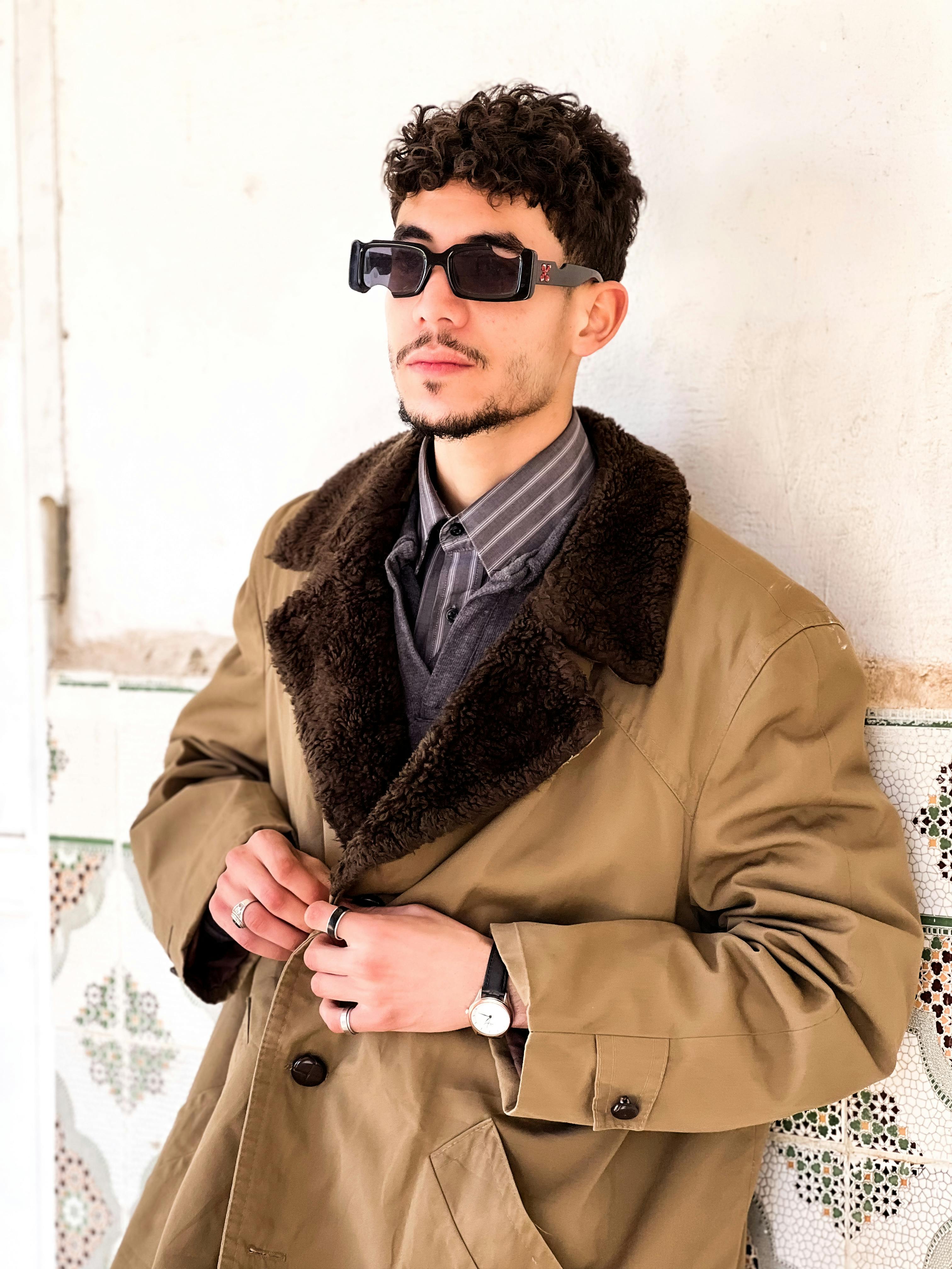 Free A stylish adult man wearing sunglasses and a coat, stylishly posed in Laghouat, Algeria. Stock Photo