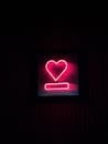 Neon Heart Sign on Dark Background at Night