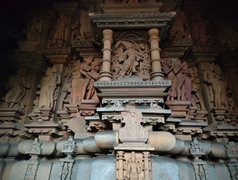 Detailed stone carvings from a temple in Khajuraho, showcasing ancient Indian art and architecture.