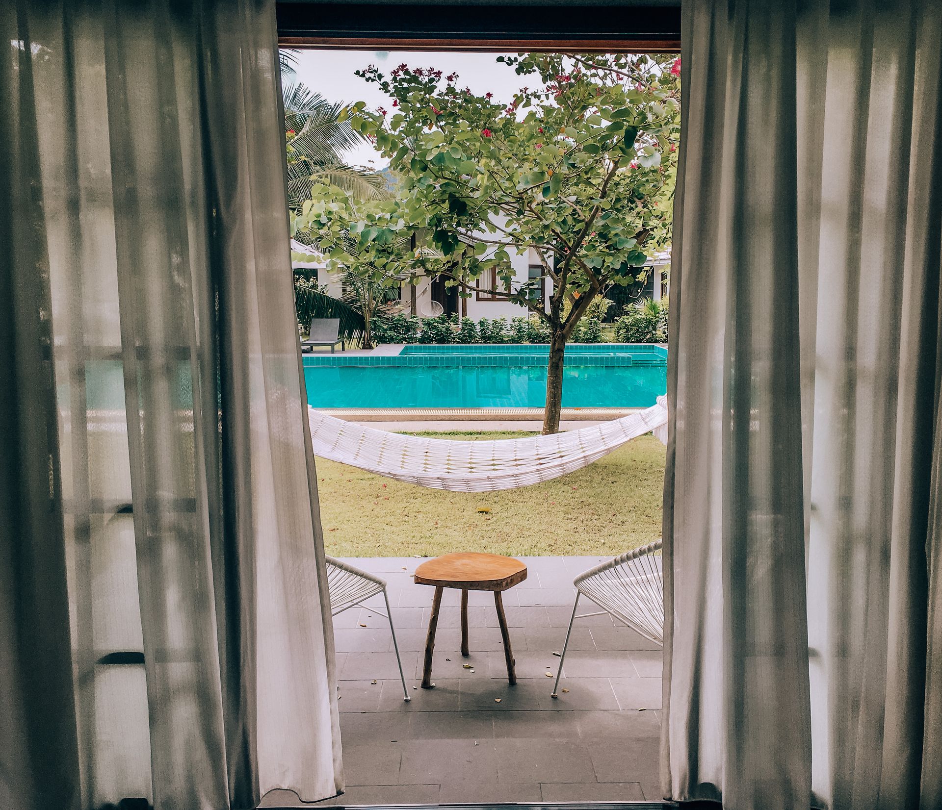 Brown Wooden Table Near Swimming Pool