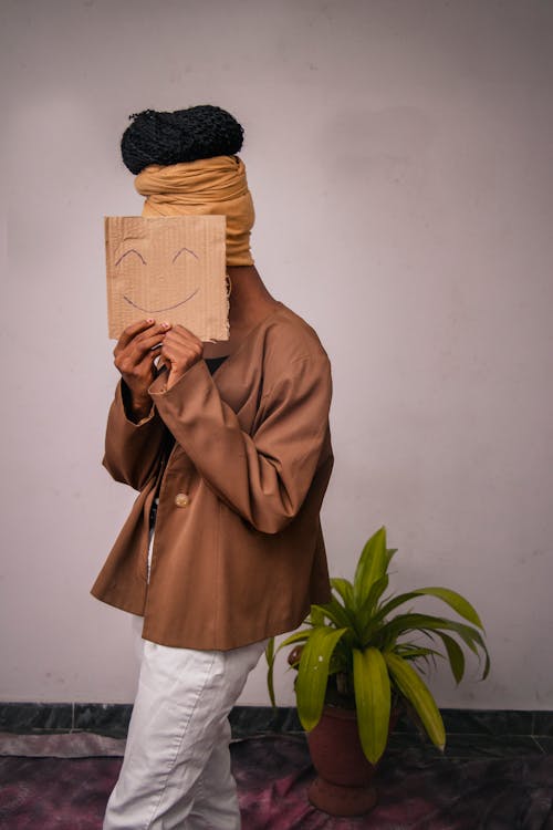 Photography of A Woman Holding A Cardboard With Emoticon