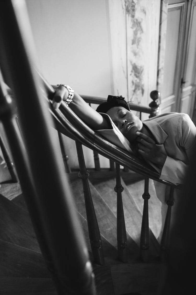 Monochrome Photo Of Person Leaning On Handrail