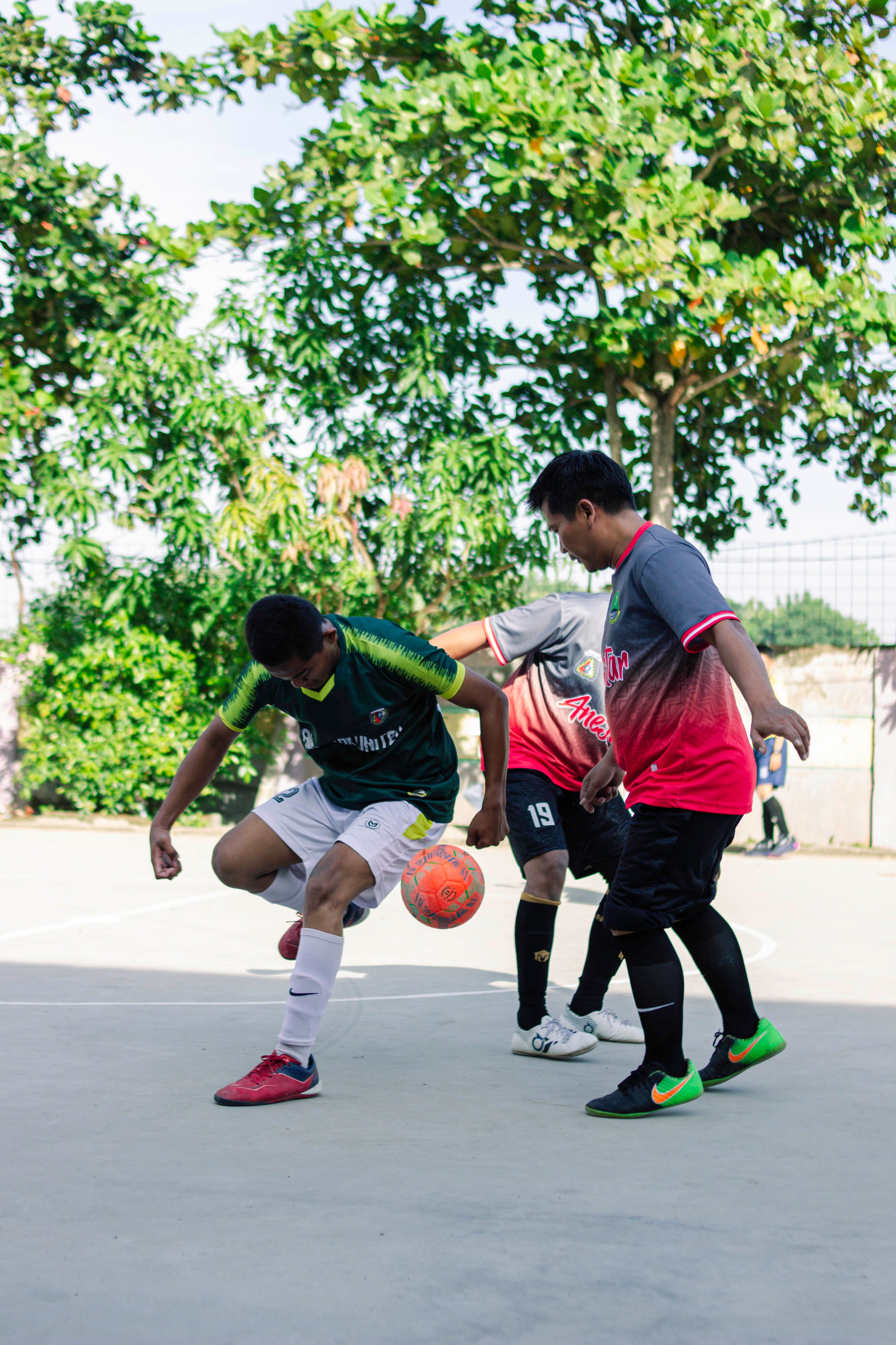 Young Men Playing Outdoor Soccer Match