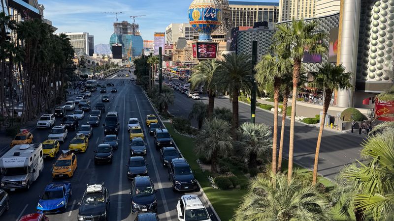 Las Vegas Strip at dusk with heavy vehicle and pedestrian traffic along the resort corridor