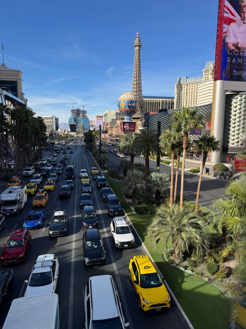 Free Vibrant Las Vegas Strip scene featuring traffic and the iconic Paris Las Vegas Eiffel Tower. Stock Photo