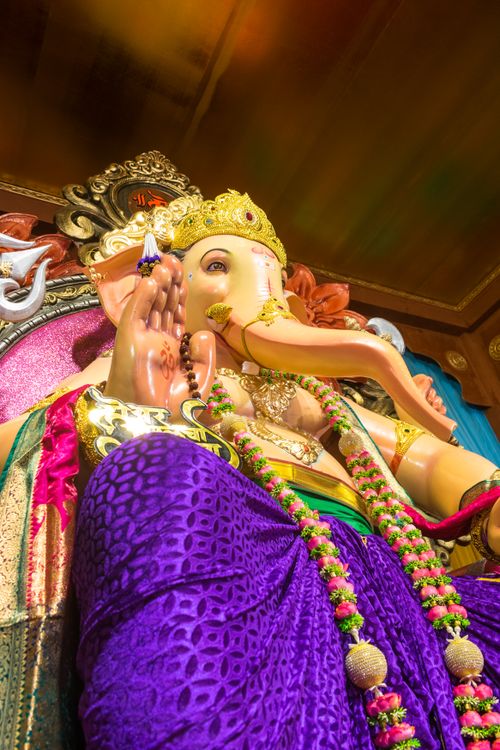 Free Vibrant Ganesh idol adorned with intricate decorations in Mumbai temple during Ganesh Chaturthi. Stock Photo