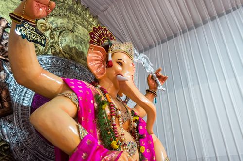 Free Colorful Ganesh statue showcased during Mumbai's Ganesh Chaturthi festival, adorned with traditional decorations. Stock Photo