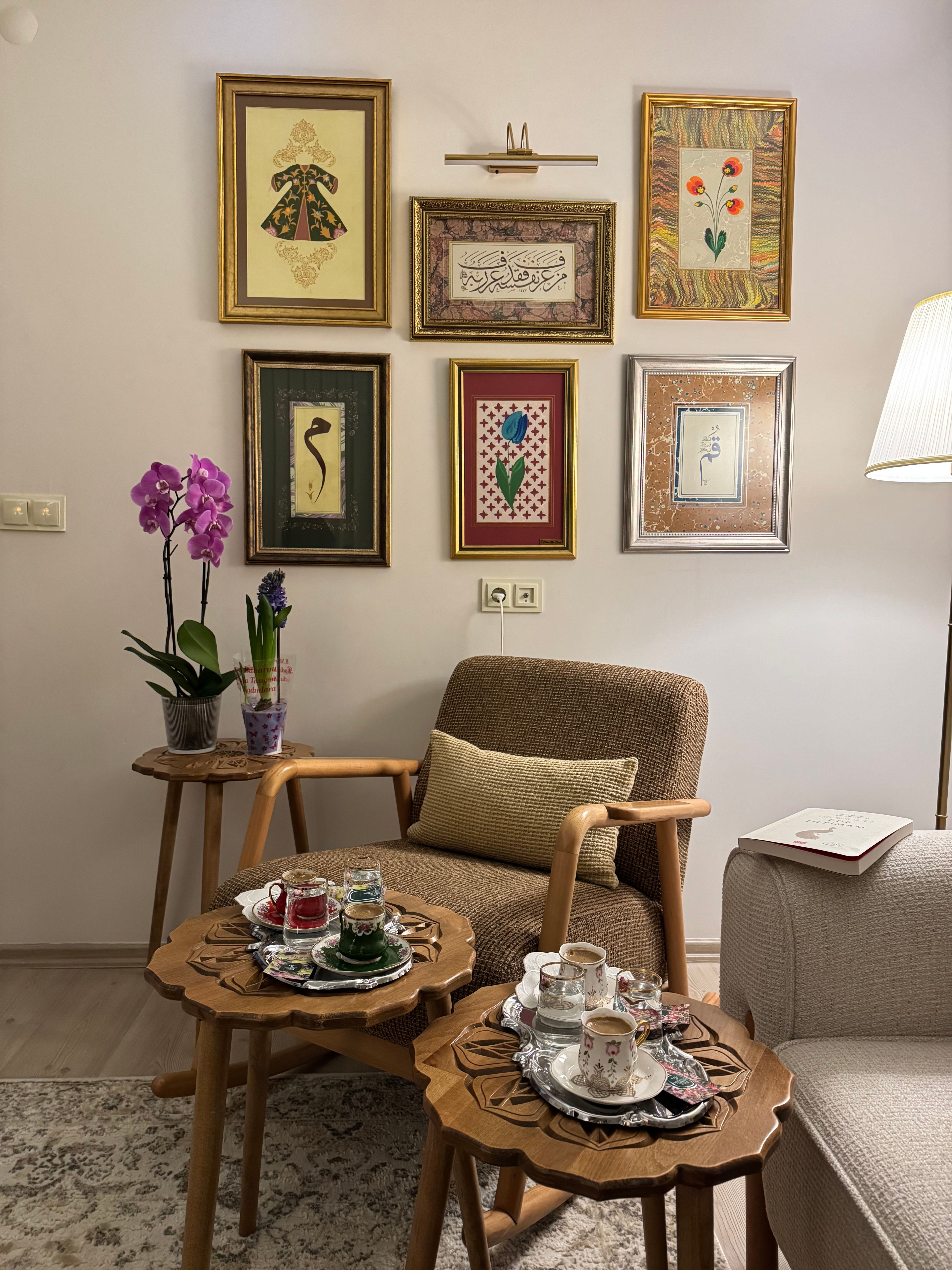 Inviting living room with traditional decor, framed art, and a Turkish tea set, perfect for a relaxing evening.