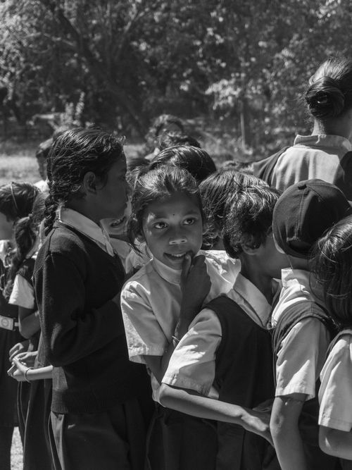 Free Group of schoolchildren standing in line outdoors captured in black and white. Stock Photo