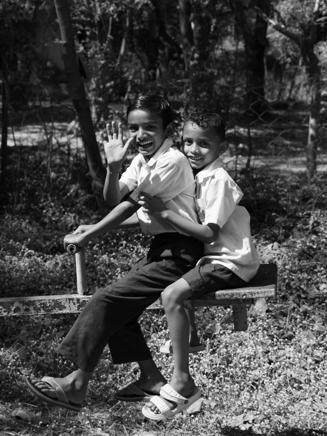Two children playing on a seesaw outdoors — illustrative photo