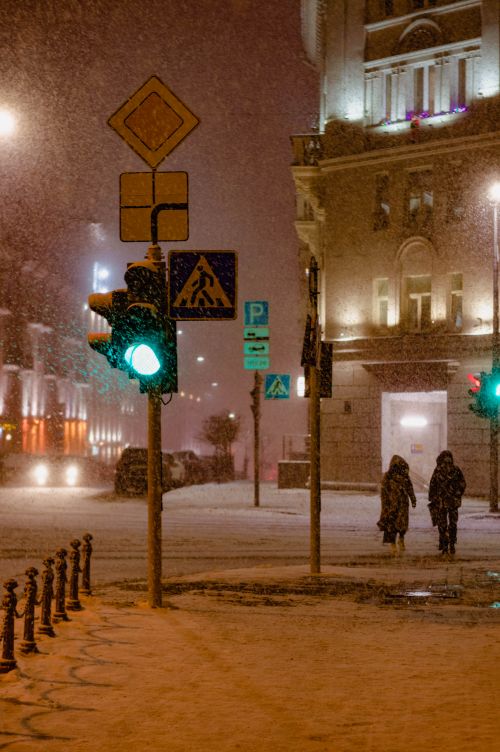 Free Captivating winter night scene in Minsk with falling snow and city lights. Stock Photo