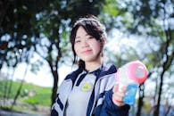 Young Woman Enjoying a Sunny Day with Toy Bubble Gun