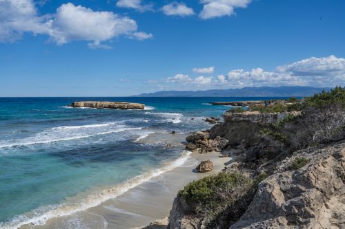 Free Beautiful rocky coastline with clear blue skies and turquoise waters in Cyprus. Stock Photo