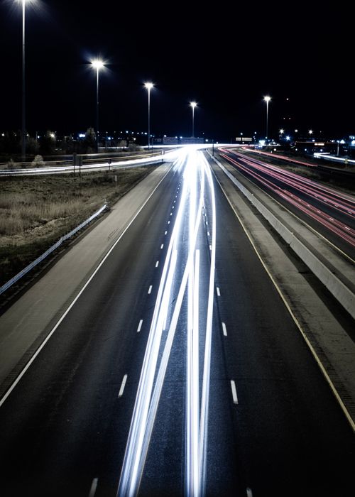 Free Aerial view of light trails on a highway in London, Ontario at night, capturing the essence of fast-moving traffic. Stock Photo