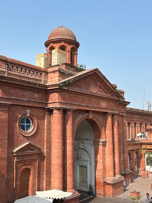 Free A historic red brick building showcasing classic columns in Amritsar, India. Stock Photo