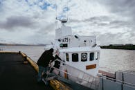 Snowy Icelandic Fjord with Docked Boat
