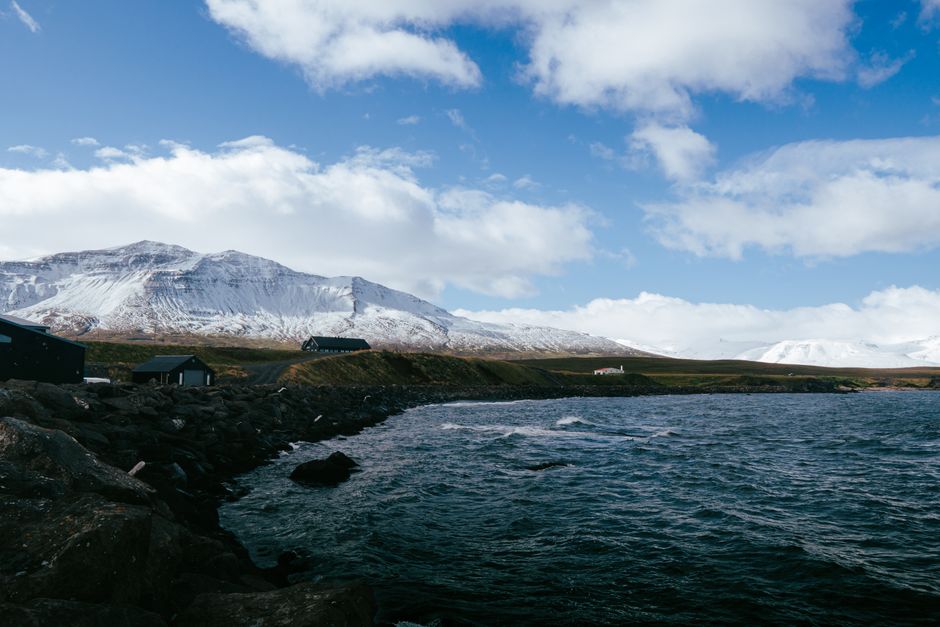 A beautiful winter landscape featuring Icelandic fjords and snowy mountains near Árskógssandur.