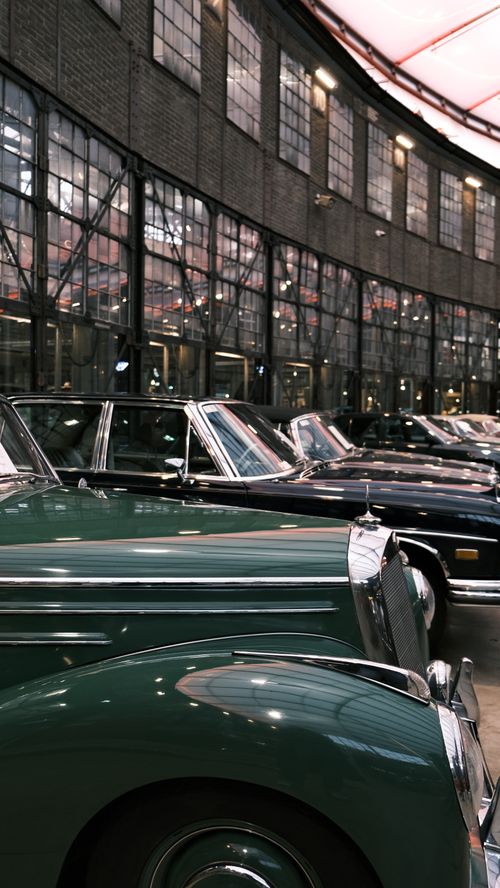 Free Vintage cars displayed in a historic indoor venue in Düsseldorf, Germany. Stock Photo