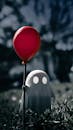 Ghost Figurine Holding Red Balloon Outdoors