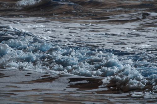 Free Dynamic waves crash against the Guaratuba shore, capturing the ocean's energy and movement. Stock Photo