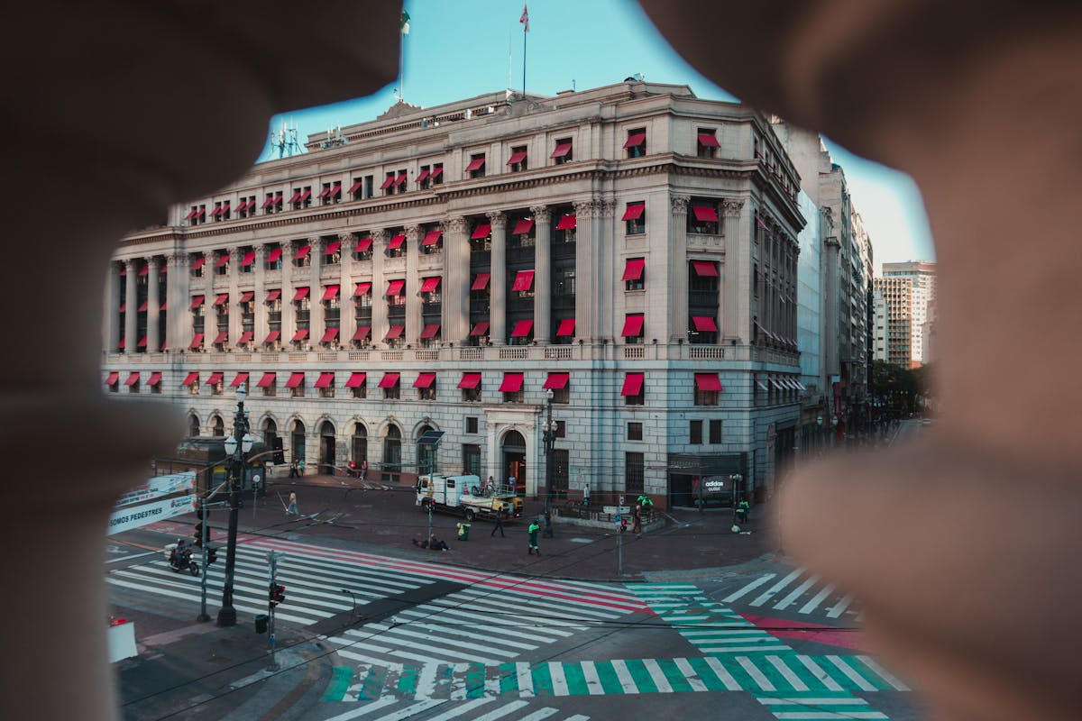 Milk being heated in a small pan on the stove with a wooden spoon