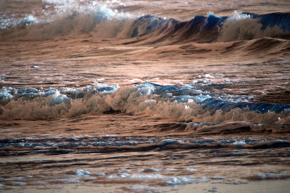 Captivating view of ocean waves under a stunning sunset glow.