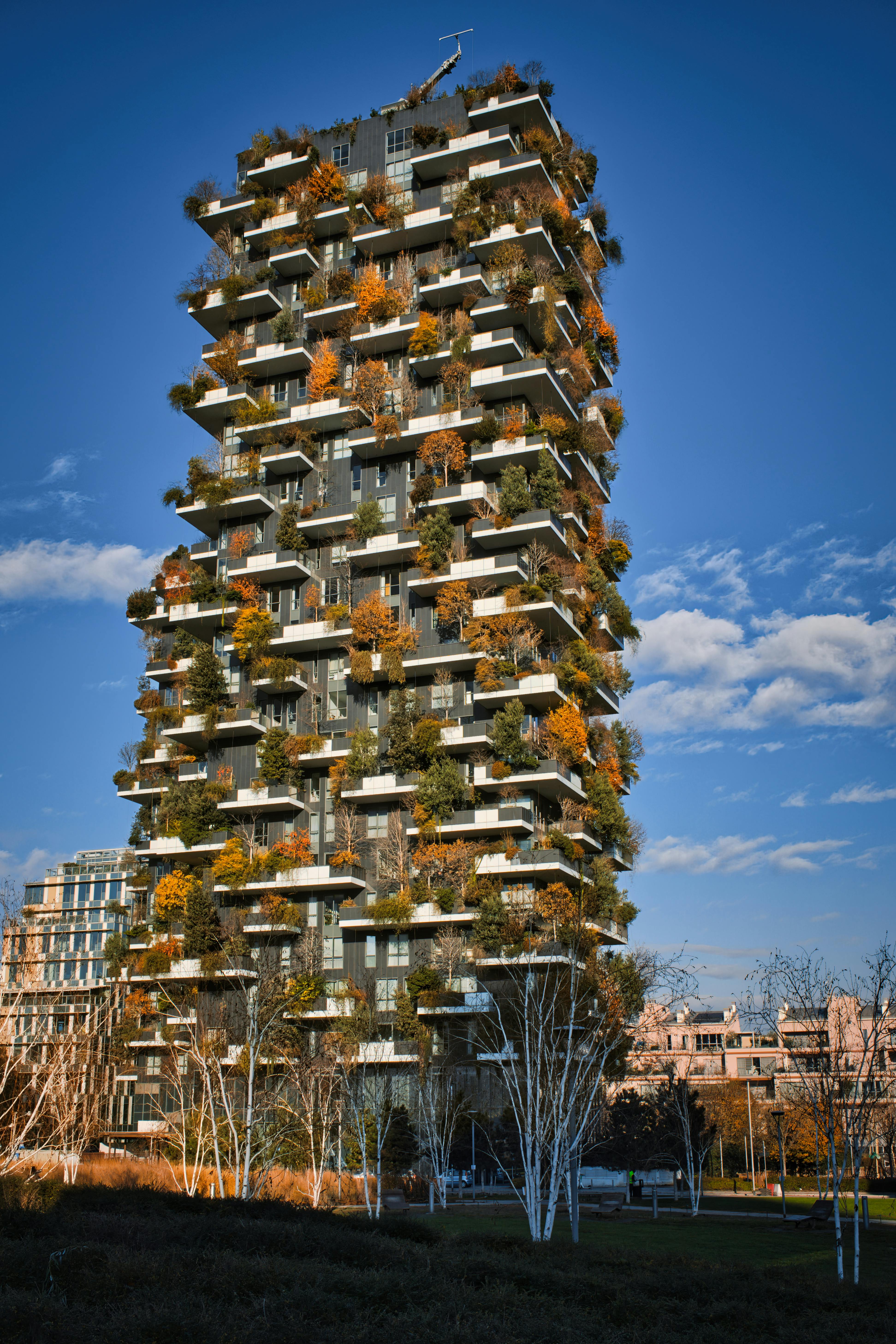 Vertical Forest building in Milan during a bright day, showcasing sustainable architecture.