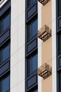 Close-up shot of a modern building facade with geometric balconies.